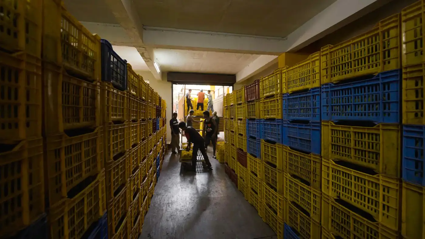 Workers loading crates in the warehouse